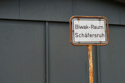 Close-up of information sign on wall
