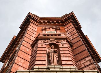 Look up old building with statue