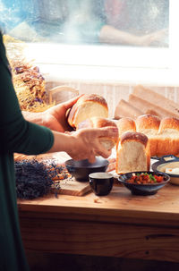 Midsection of man having food at home