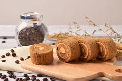 Close-up of breads and coffee beans on table