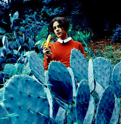 Portrait of woman standing against plants