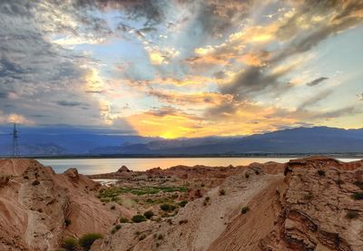 Scenic view of beach against sky during sunset