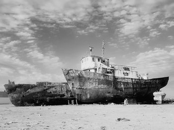 Old ship on sea against sky