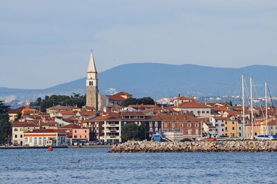 Traditional church by sea against sky