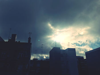 Low angle view of silhouette buildings against sky at sunset