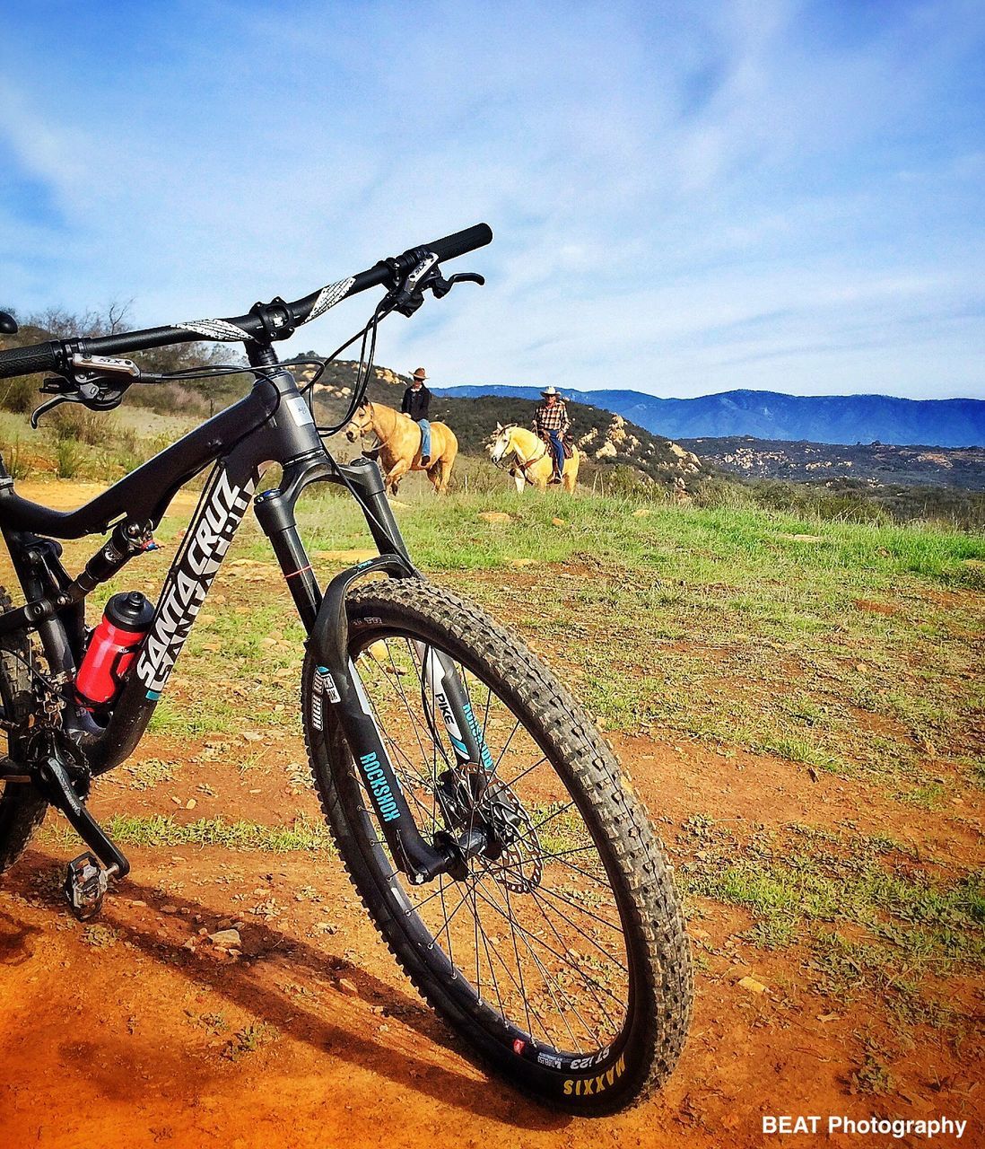 bicycle, transportation, land vehicle, sky, mode of transport, landscape, field, grass, tranquility, stationary, parked, tranquil scene, scenics, cloud - sky, nature, parking, mountain, beauty in nature, day, non-urban scene