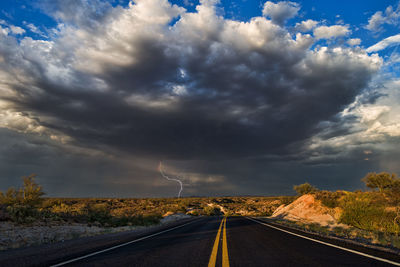 Storm clouds over empty road