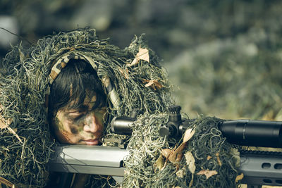 Close-up of army soldier aiming gun