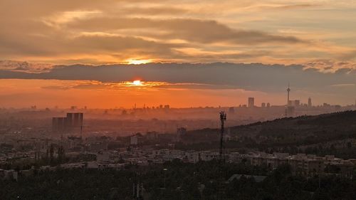 High angle view of buildings against sky during sunset