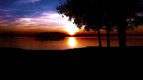 Scenic view of lake against orange sky