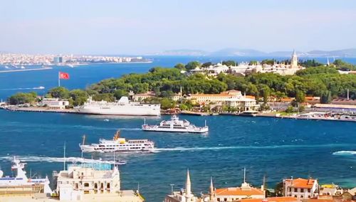 Sailboats in city at waterfront