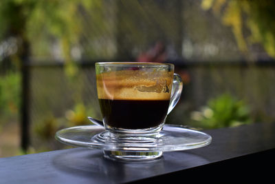 Close-up of coffee in glass on table