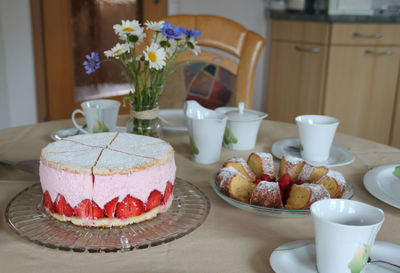 Cake served on table at home