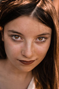 Close-up portrait of a smiling young woman