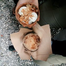 High angle view of woman holding coffee cup on table