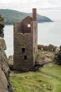 Historic building by sea against sky