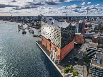 High angle view of city buildings against cloudy sky hamburg elbphilamonie 