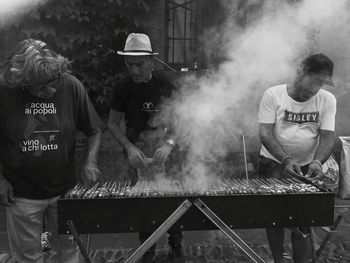 People standing on barbecue grill