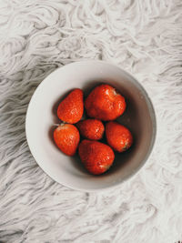 High angle view of strawberries in bowl on table