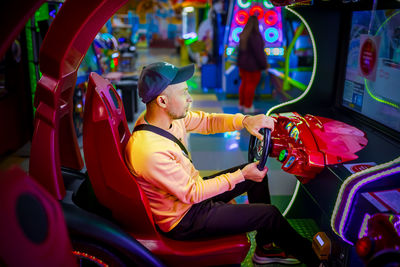 Rear view of man sitting in car