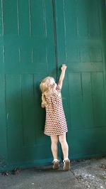 Full length of girl standing in front of boy