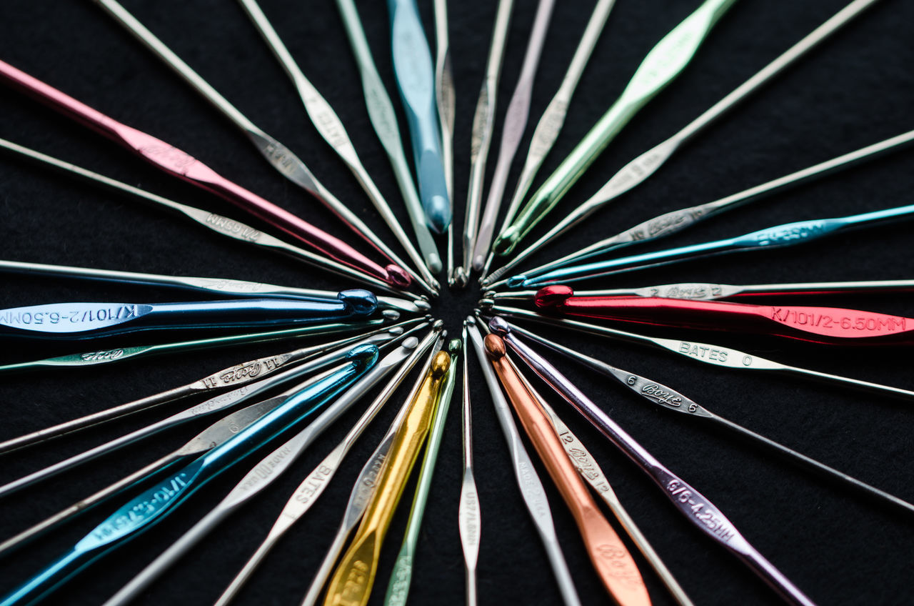CLOSE-UP OF MULTI COLORED PENCILS AGAINST BLACK BACKGROUND