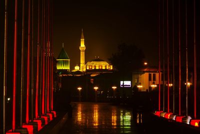Illuminated mevlana mosque against sky at night