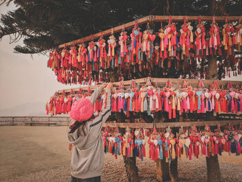 Woman standing in row for sale at market stall