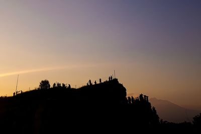 Silhouette of temple against sky during sunset