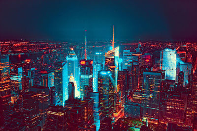 Aerial view of illuminated buildings in city at night