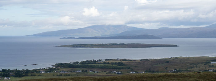 Scenic view of sea and mountains against sky