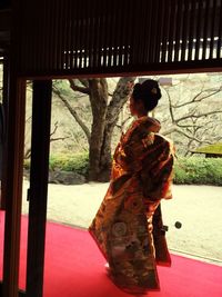 Woman standing by railing