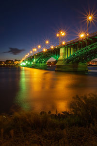 Scenic view of mainz with illuminated theodor heuss bridge against sky at night 