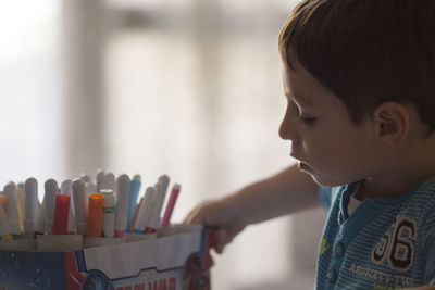 Close-up of boy looking at felt tip pens