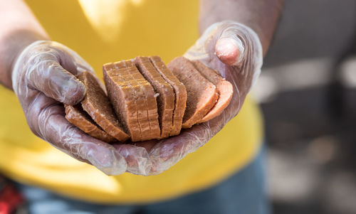 Mid section of man holding breads