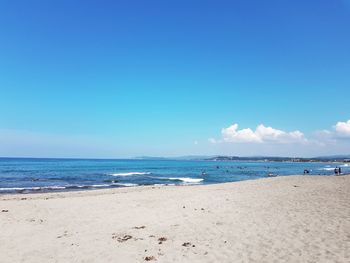 Scenic view of beach against blue sky