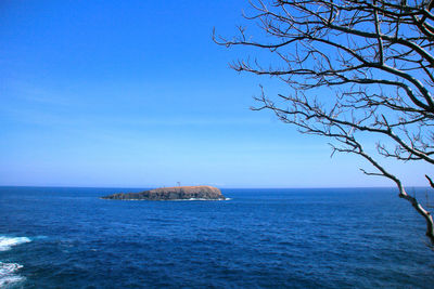 Scenic view of sea against clear blue sky