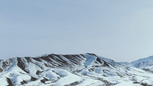 Scenic view of snowcapped mountains against clear sky