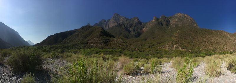 Panoramic view of rocky mountains against clear sky