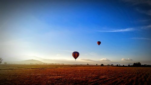 Hot air balloon flying over beach