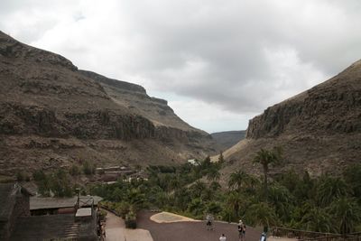 Scenic view of mountains against cloudy sky