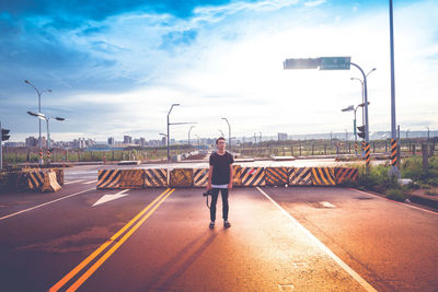 Rear view of man standing on road