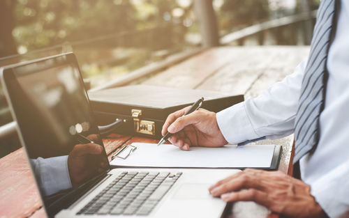 Low angle view of man using laptop on table