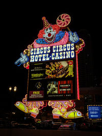 Low angle view of illuminated sign at night