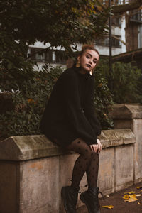 Portrait of young woman sitting on staircase