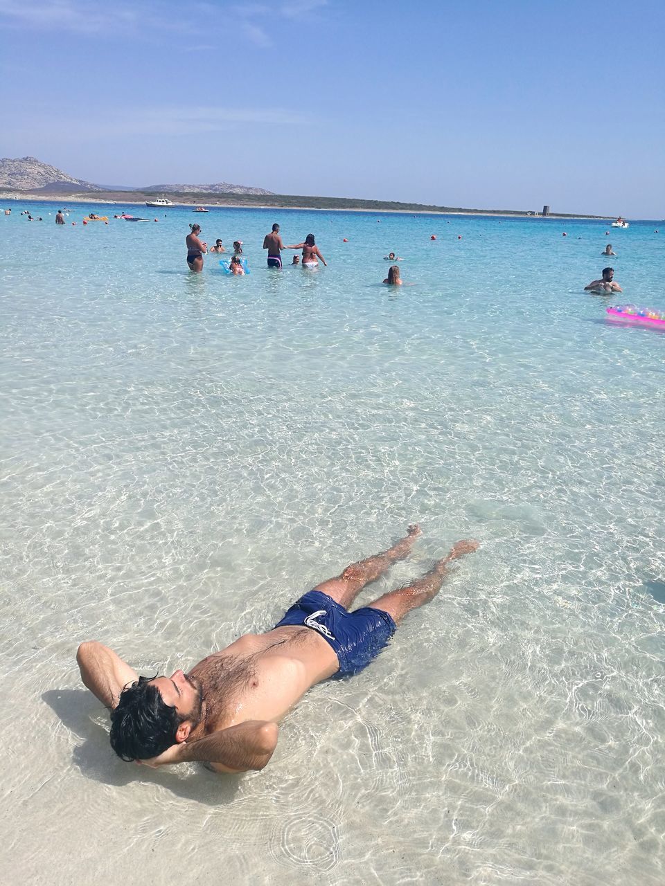 beach, sea, sand, water, horizon over water, full length, day, outdoors, real people, nature, sky, vacations, men, lifestyles, leisure activity, beauty in nature, summer, scenics, clear sky, low section, young adult, adult, adults only, people