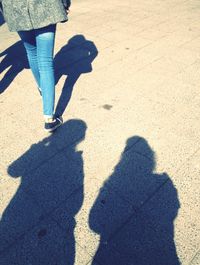 Low section of people standing on tiled floor