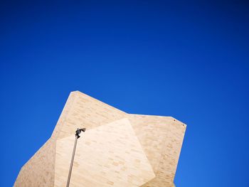 Low angle view of cross against clear blue sky