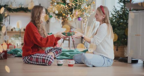 Side view of girl playing with toy on table