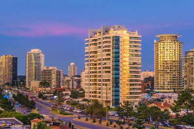 Modern buildings in city against sky